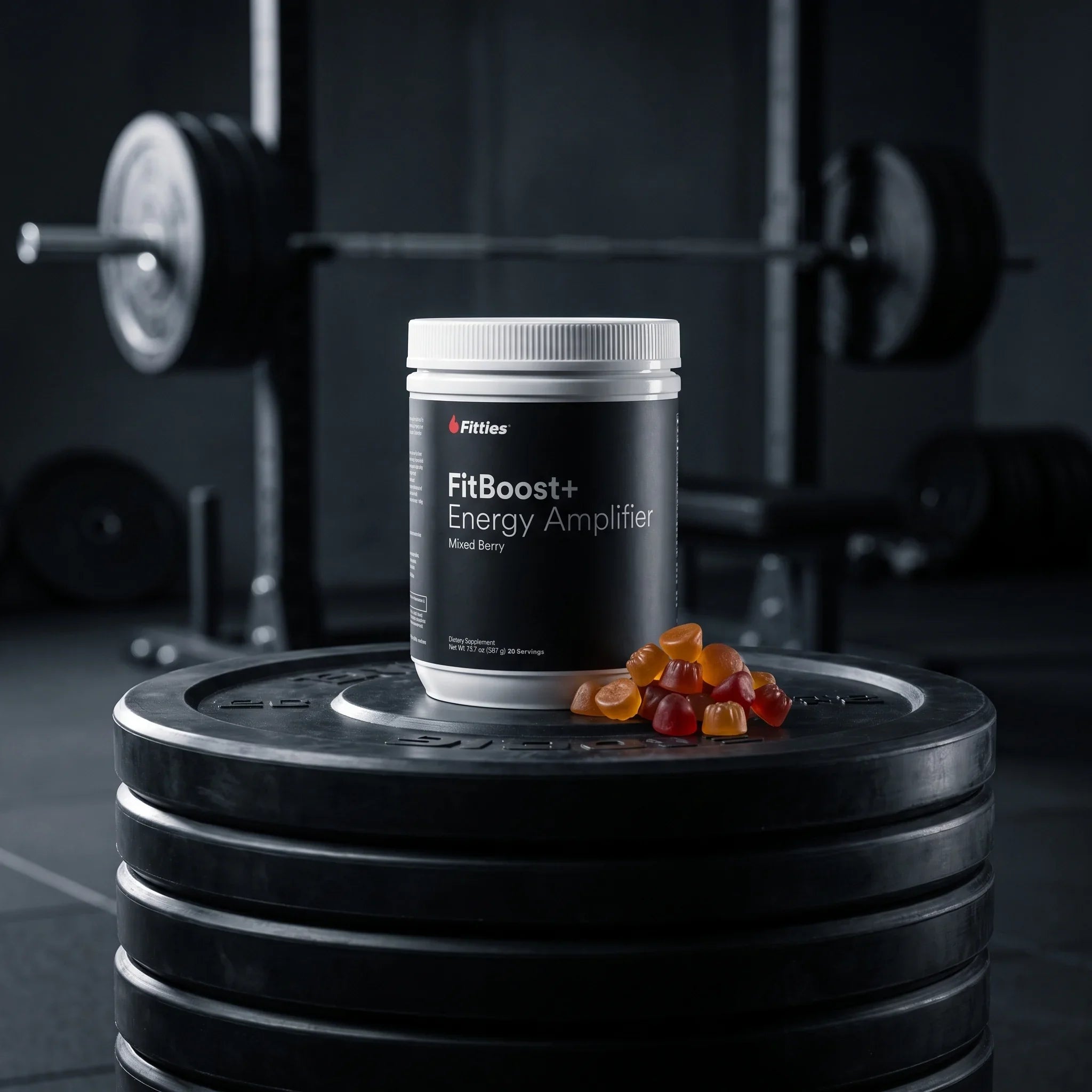 FitBoost+ creatine powder tub and creatine gummies on a stack of gym weight plates