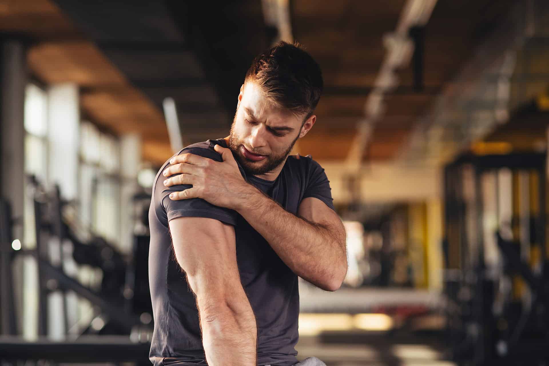 Man holding his shoulder in discomfort