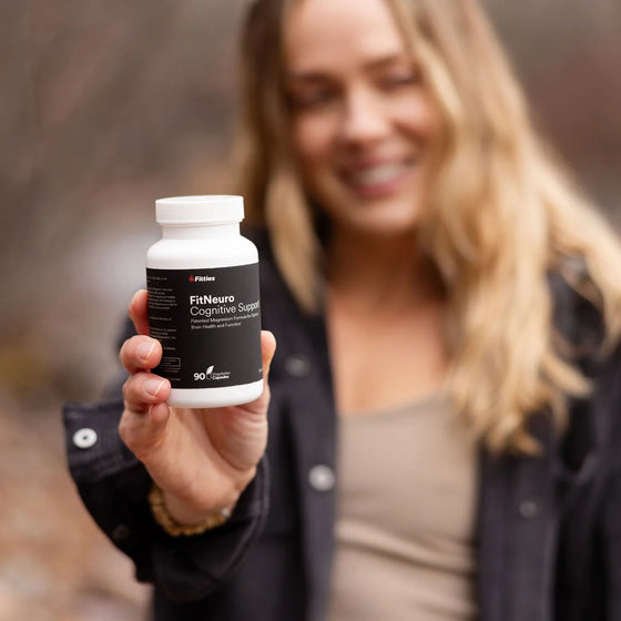 Athlete holding a bottle of Fitties FitNeuro magnesium L-threonate supplement