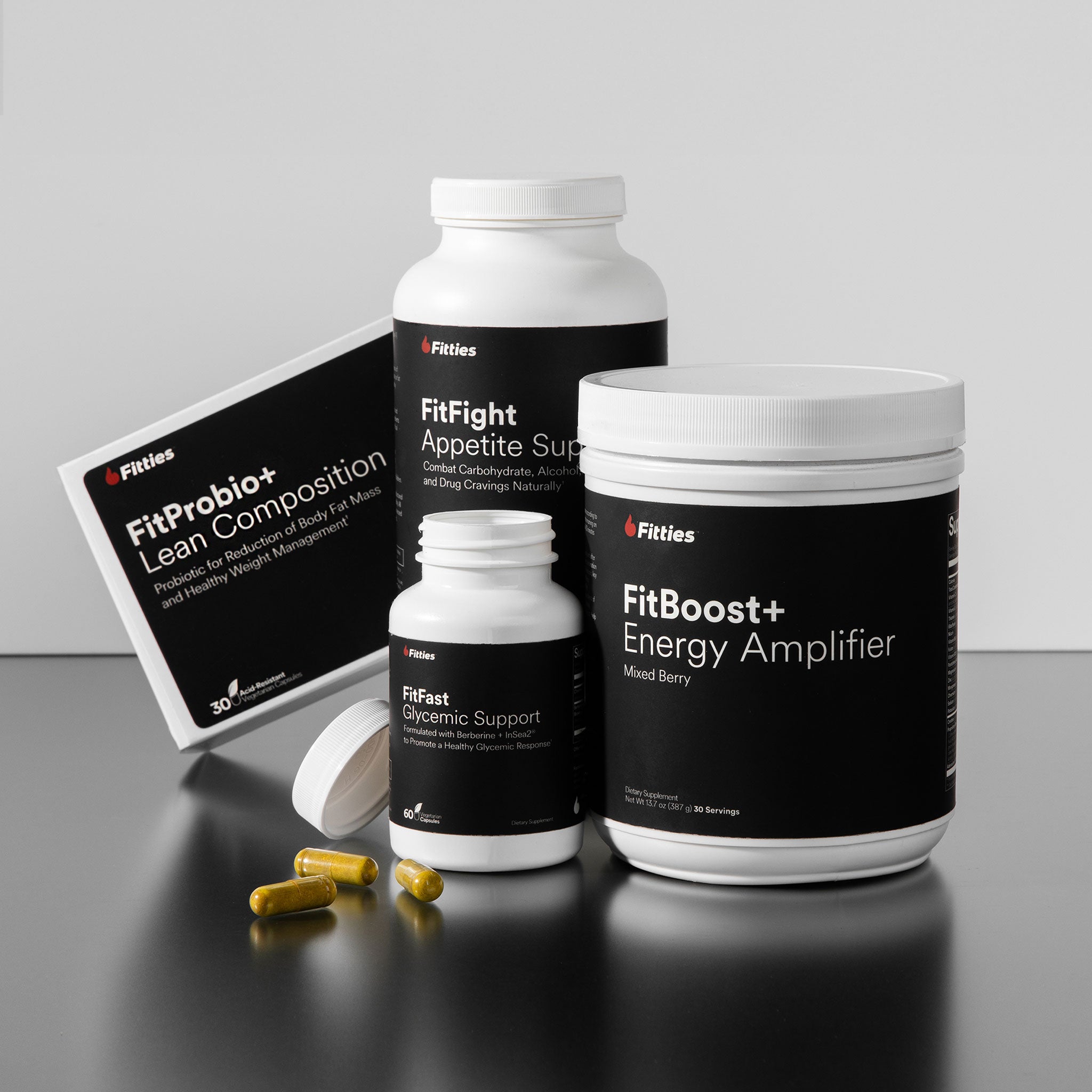 Collection of Fitties supplement products on a gray background