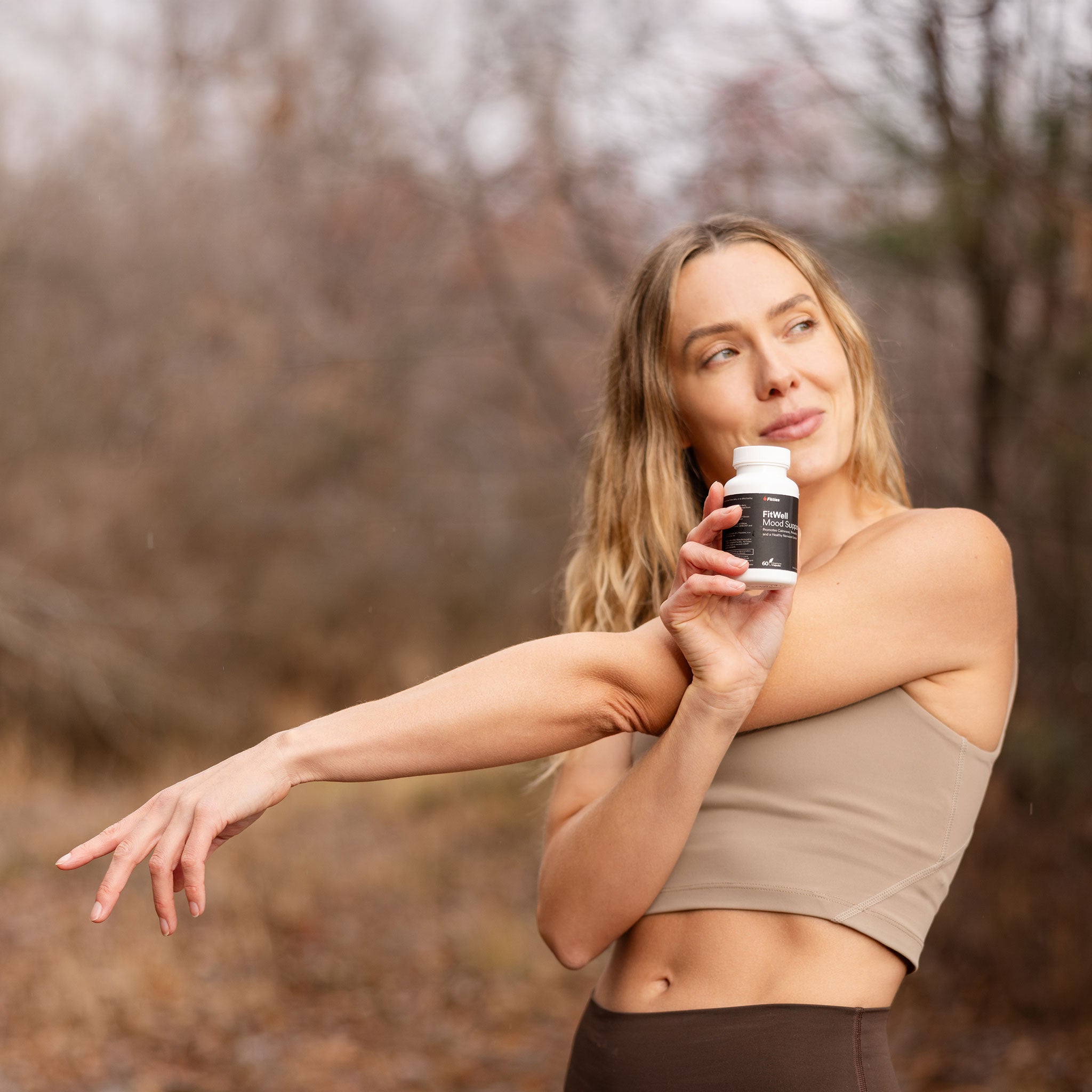Stretching Fitties ambassador outdoors with FitWell