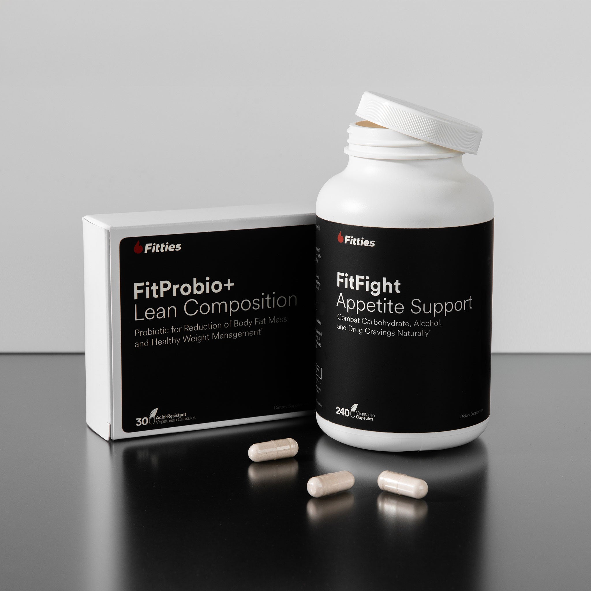 Fitties FitProbio+ Lean Composition and FitFight Appetite Support packaging on a gray background