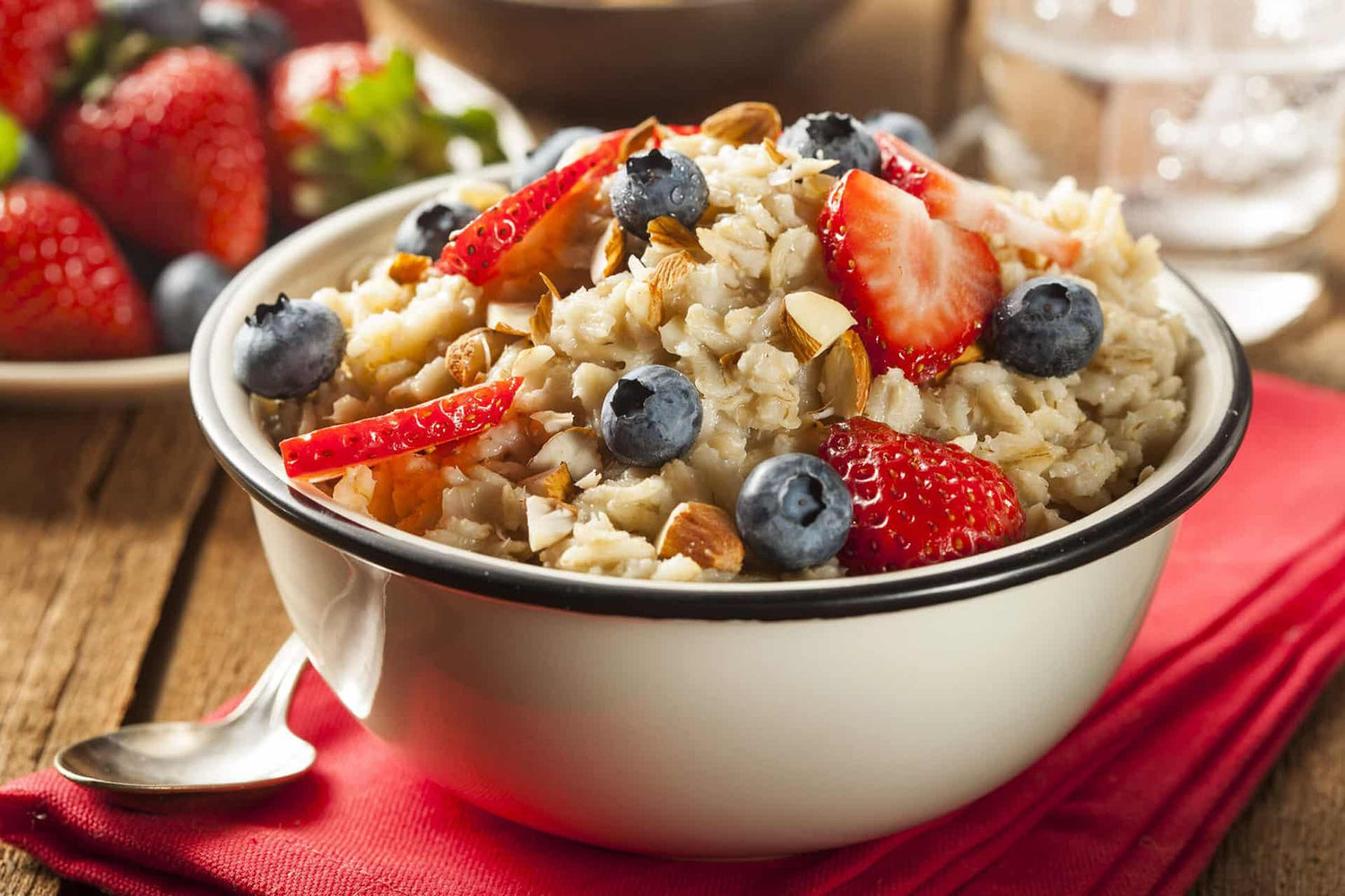 Bowl of protein infused oatmeal with fresh berries and sliced almonds