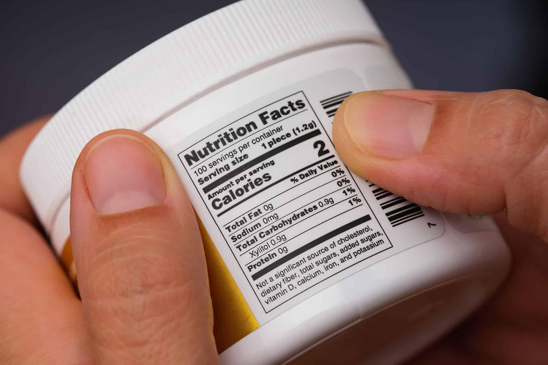 Closeup of Supplement Facts panel on a supplement container showing serving size and ingredient details