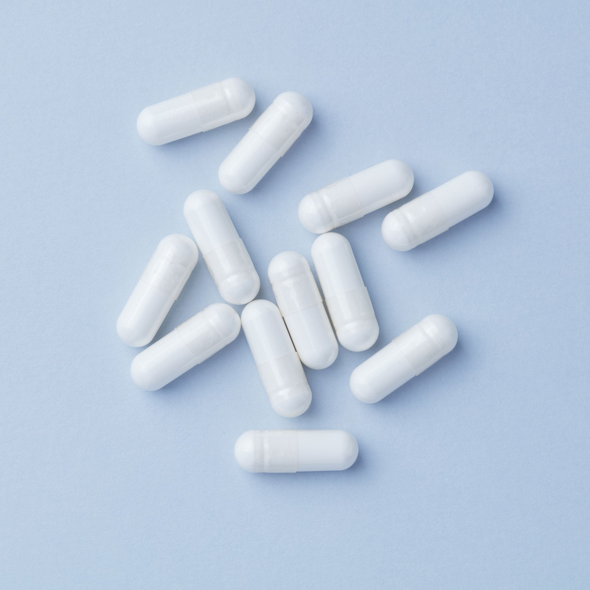 Creatine monohydrate supplement capsules on a clean surface, representing the most researched sports nutrition ingredient