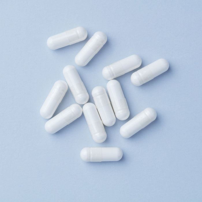 Creatine monohydrate supplement capsules on a clean surface, representing the most researched sports nutrition ingredient