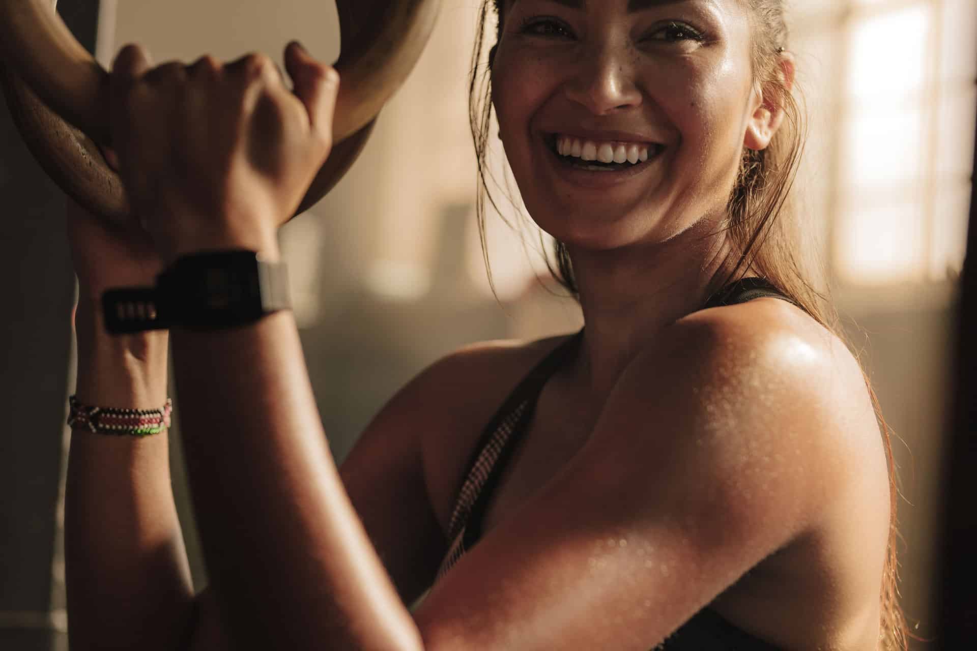 Smiling woman representing how exercise supports stress relief