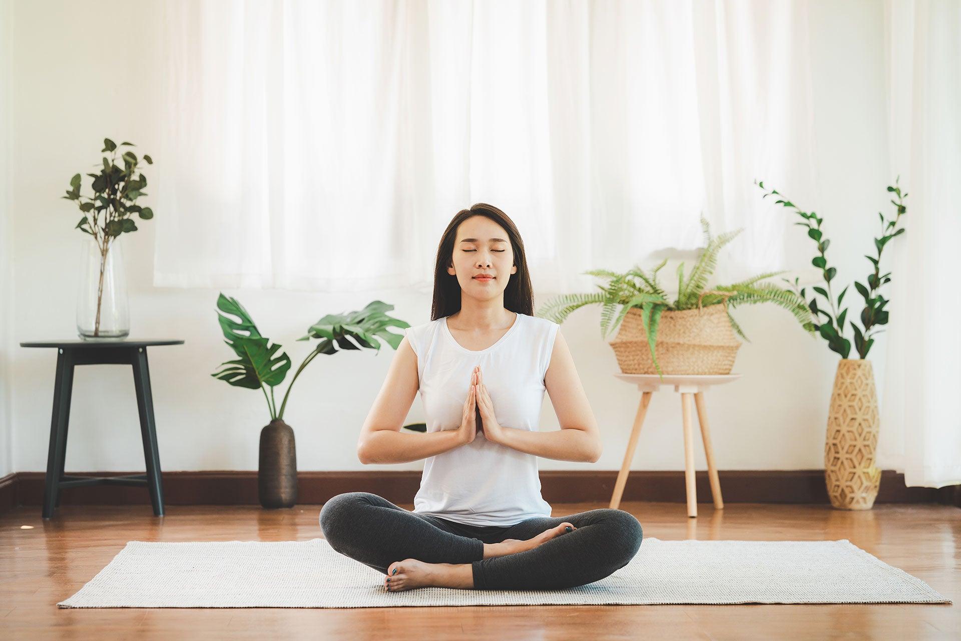 Female meditating at home