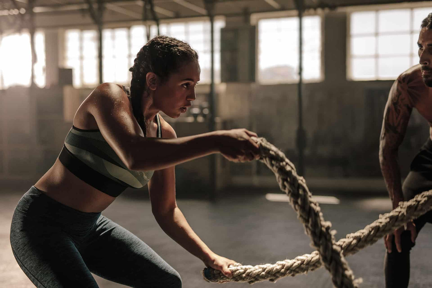 Female performing exercises with battle ropes