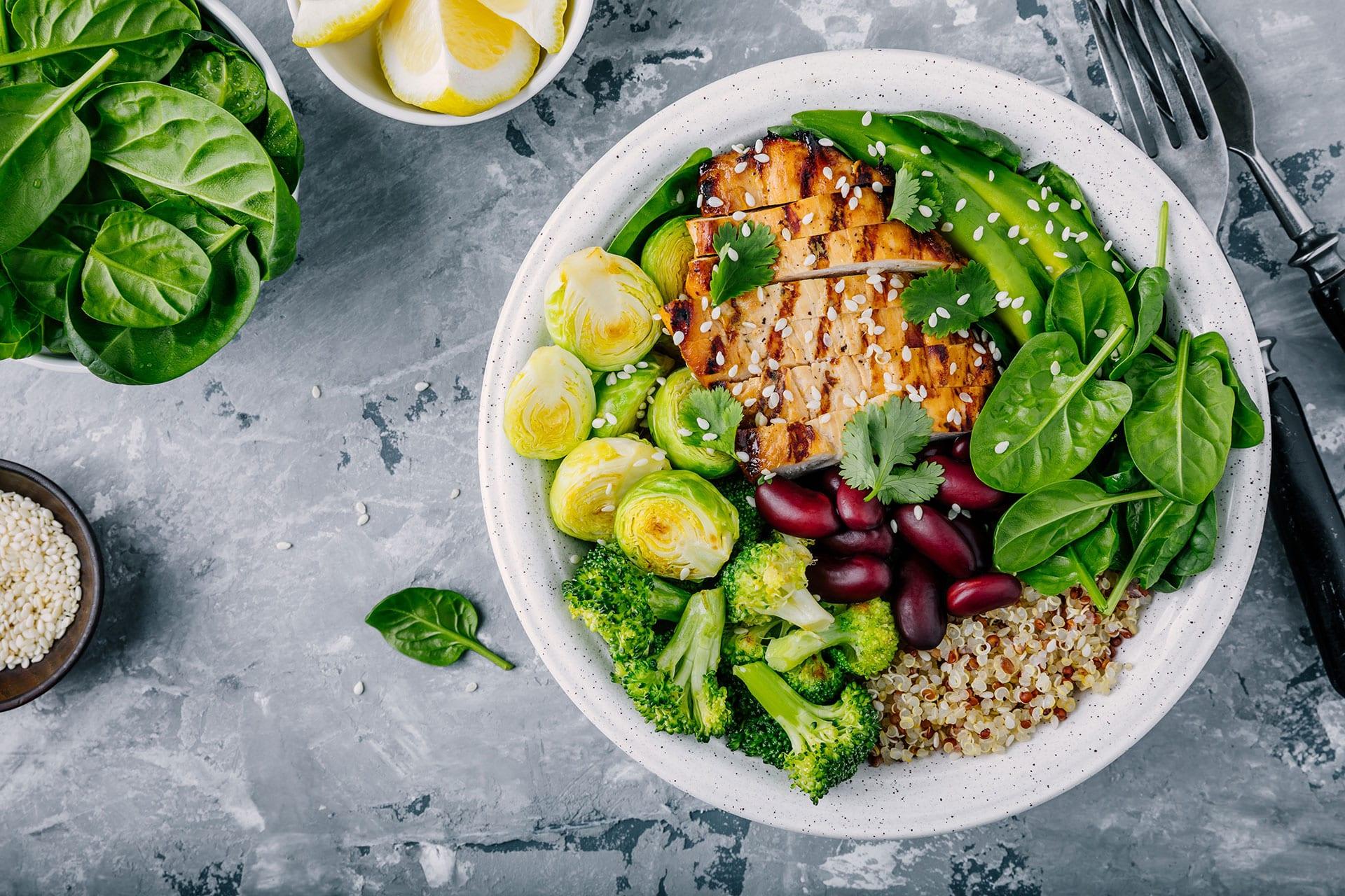 Overhead closeup of chicken salad in bowl on industrial tabletop