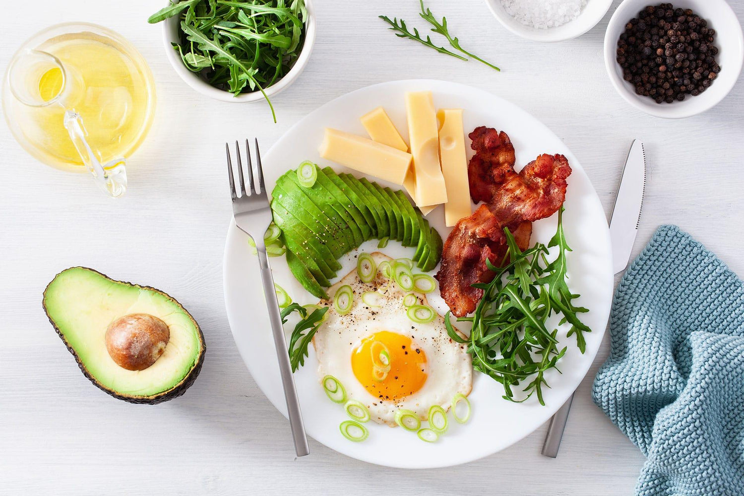 Overhead view of keto-friendly brunch foods on white table
