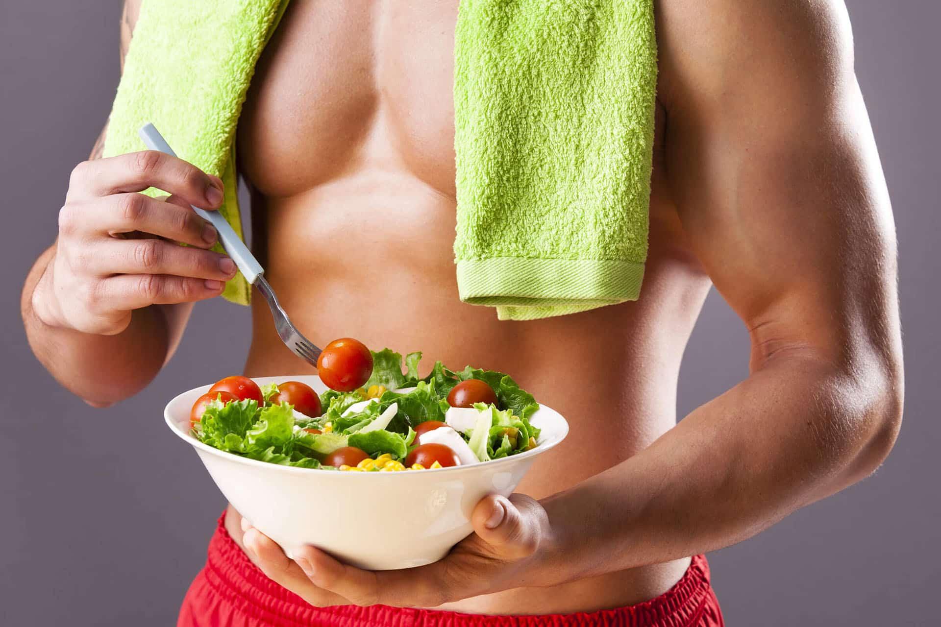 Fit male holding bow of salad