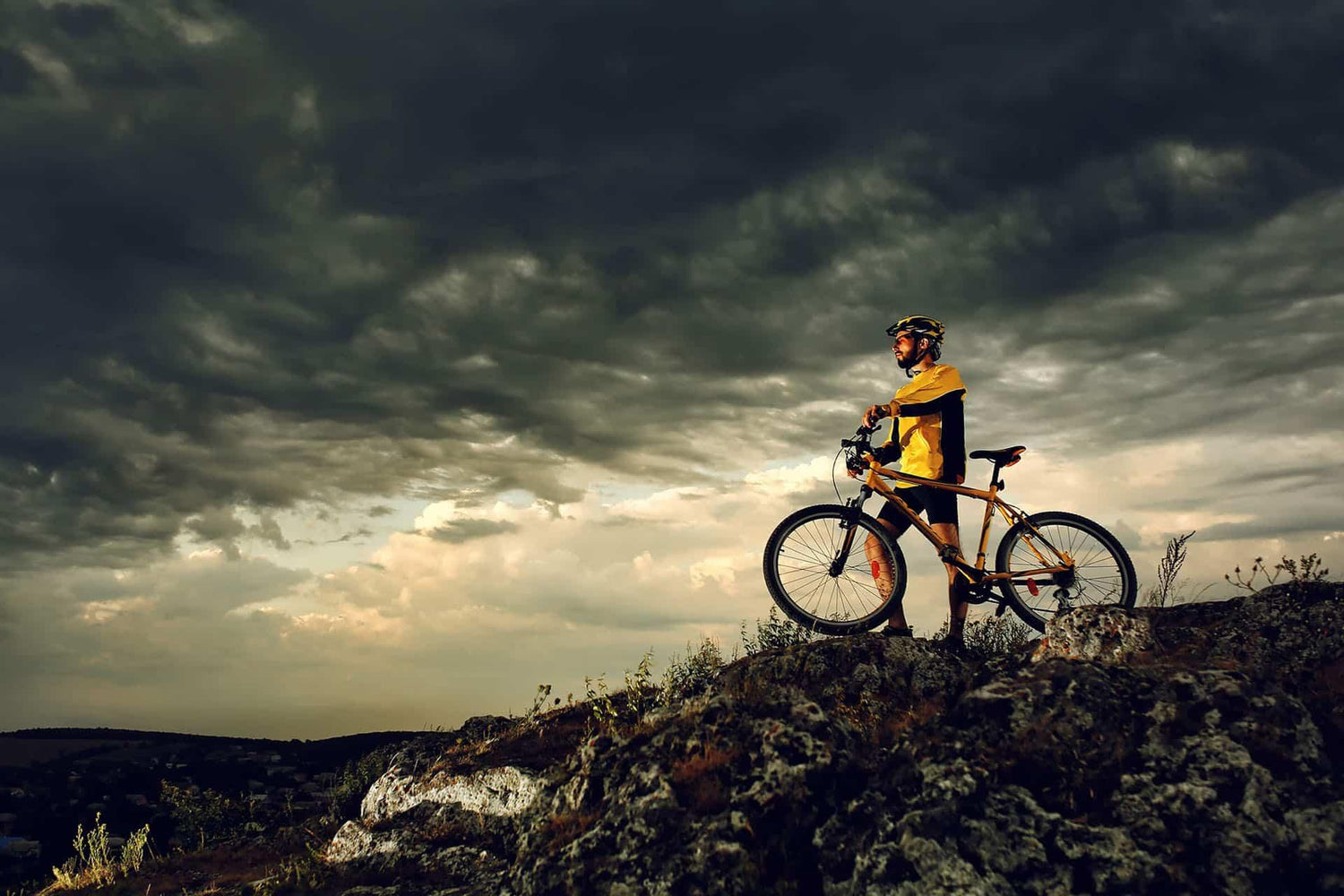 Male mountain biker watching storm