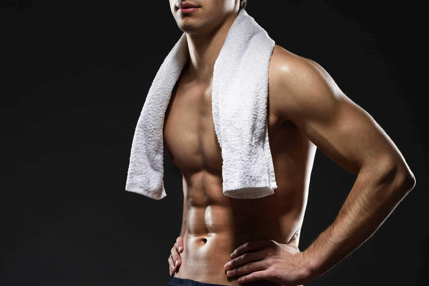 Fit man with white towel around his shoulders