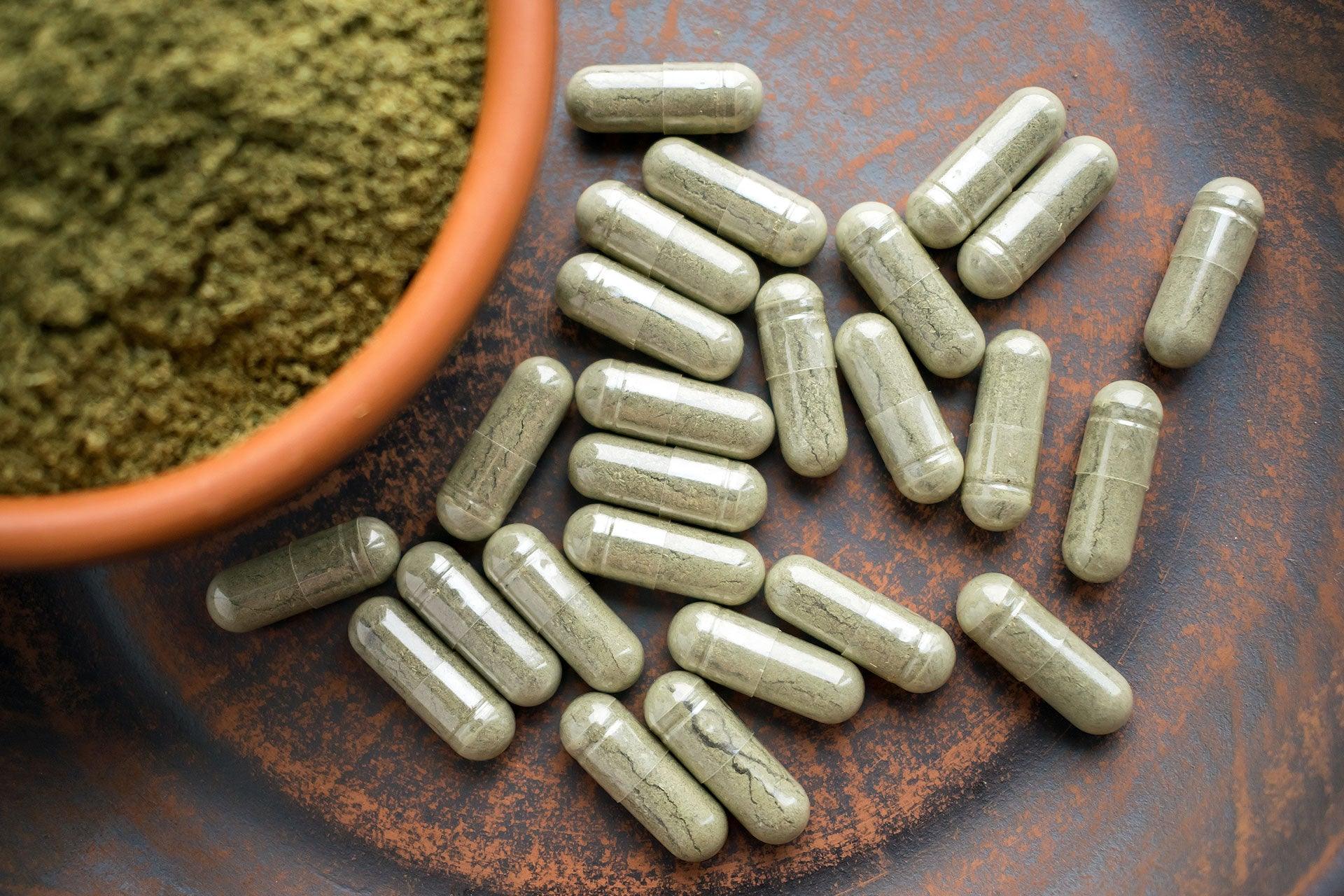 Closeup overhead view of herbal powder and capsules