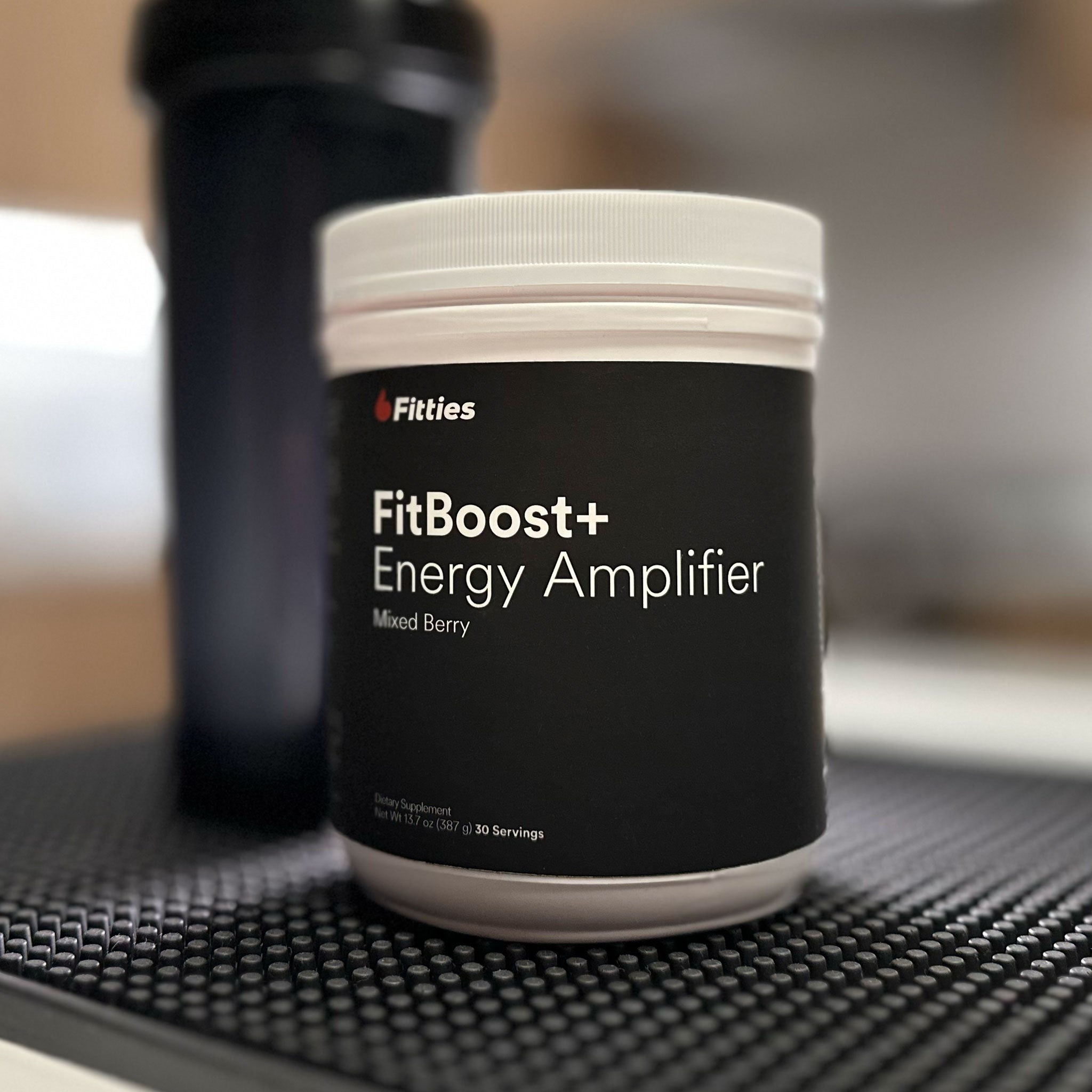 Closeup of container of FitBoost+ on counter