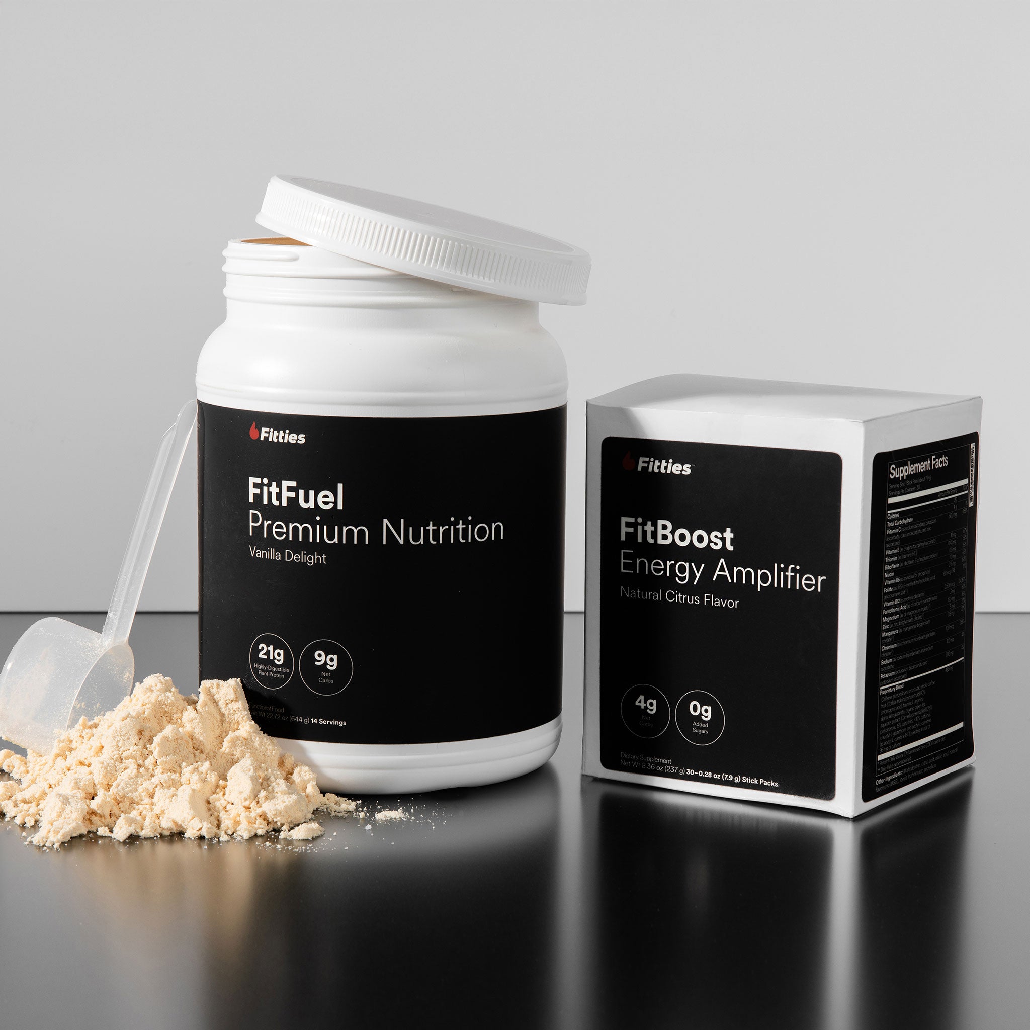FitFuel premium nutrition powder with scoop and FitBoost energy amplifier packaging on a gray background