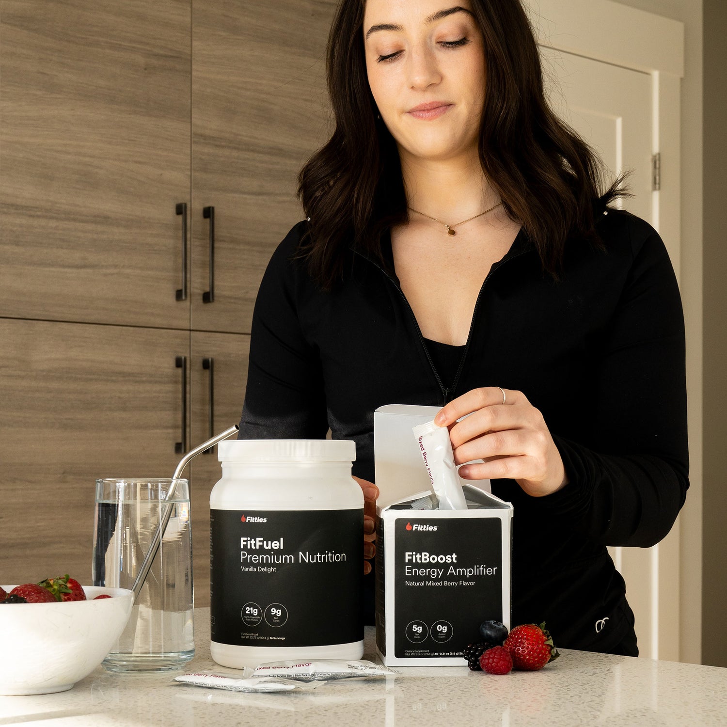 Female pulling packet of FitBoost from box in kitchen