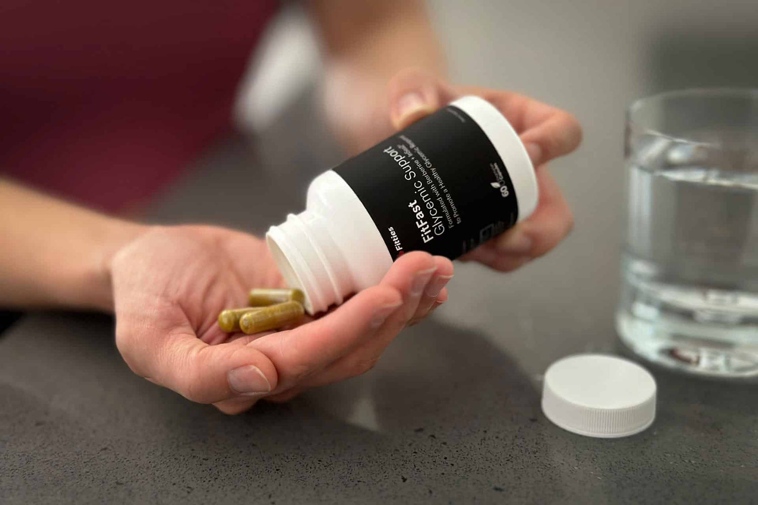Closeup of FitFast bottle and capsules in hand