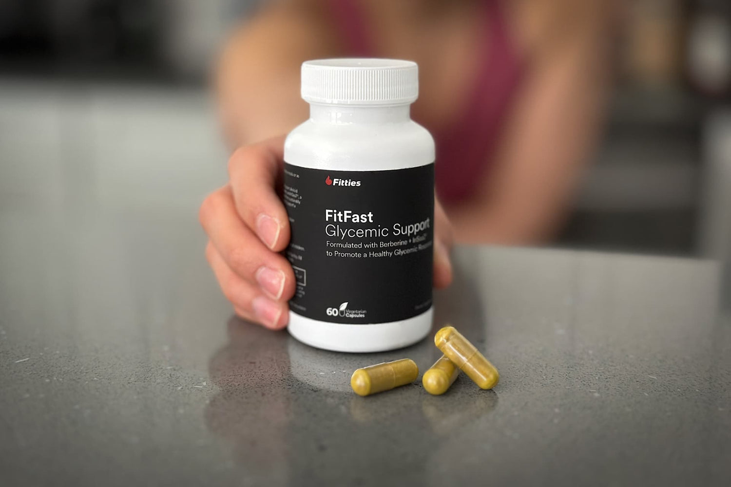 Closeup of FitFast bottle and capsules on kitchen counter