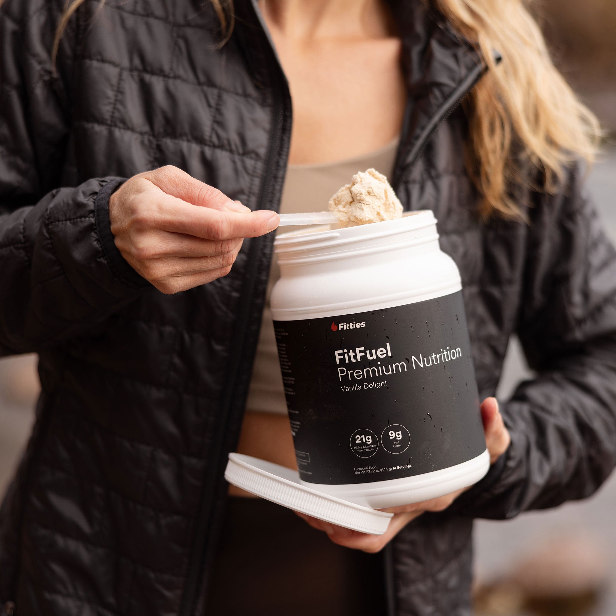 Athlete scooping FitFuel outdoors