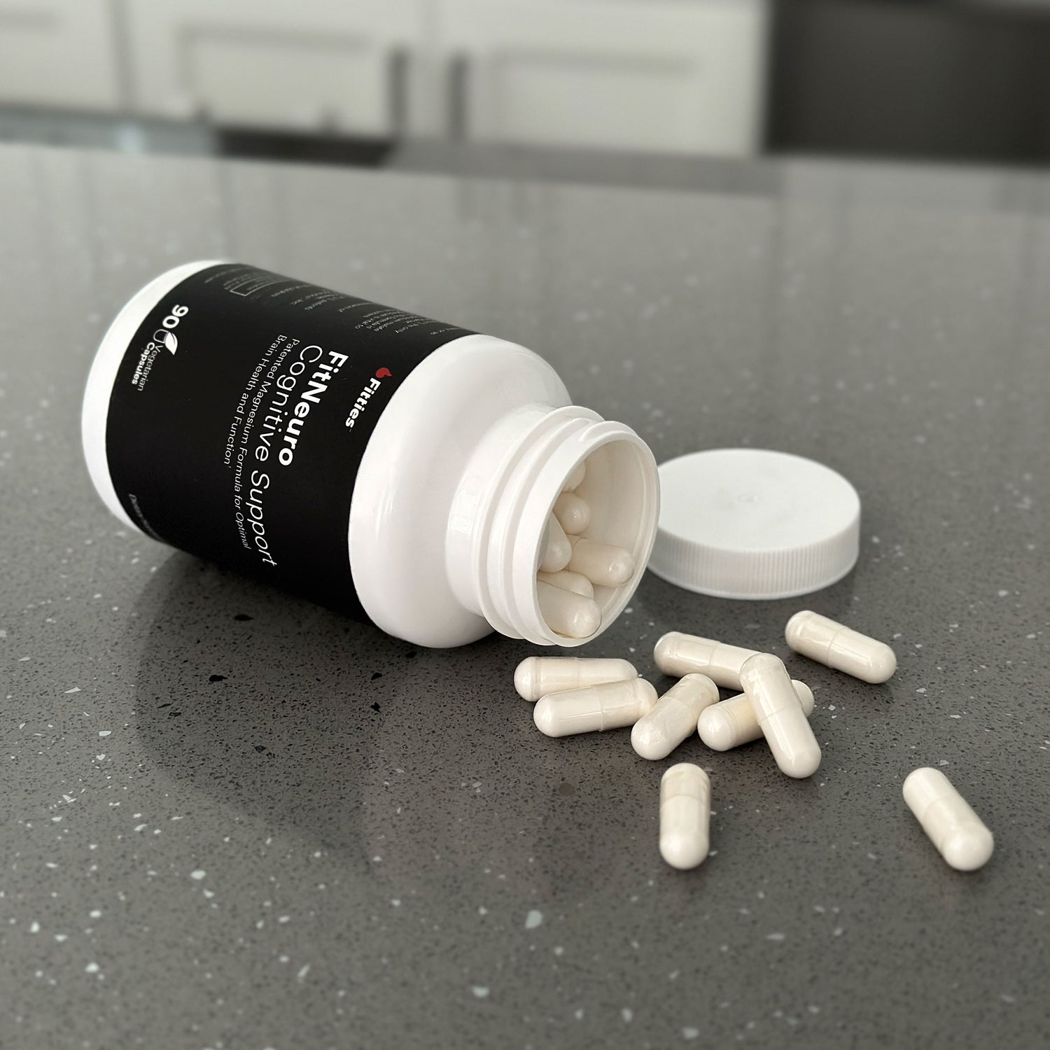 Closeup of Fitties FitNeuro bottle and capsules