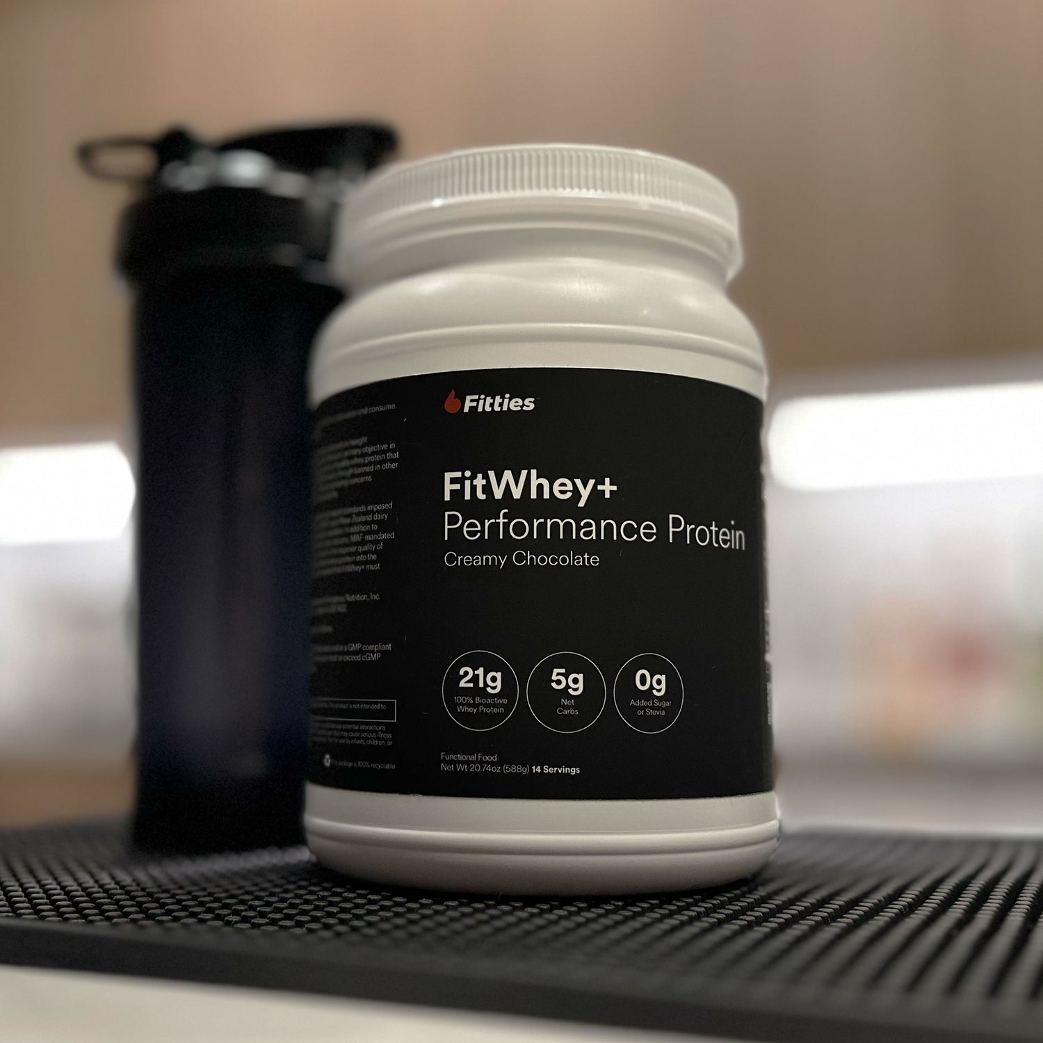 Closeup of FitWhey+ container on counter
