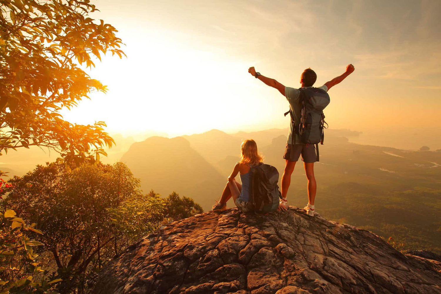 Wide view of male and female on mountain top