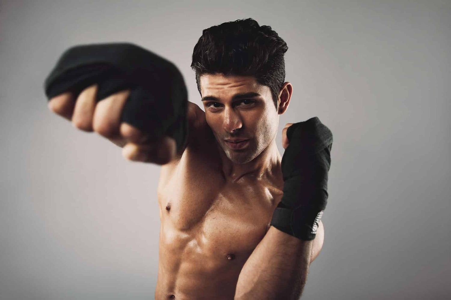 Closeup of male boxer performing right jab