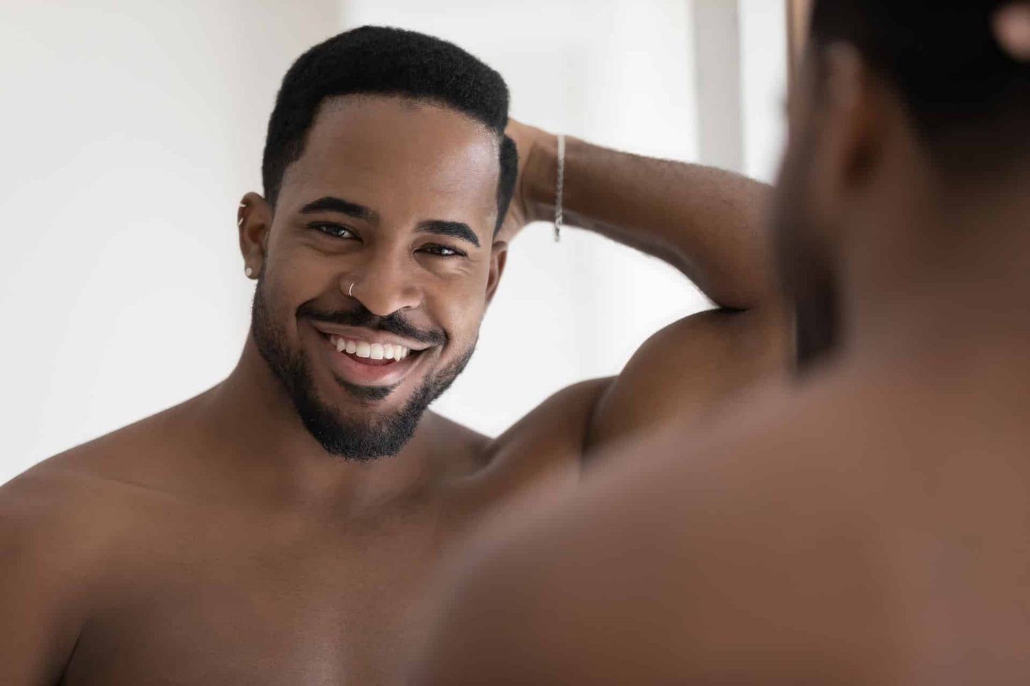 Fit male smiling in mirror