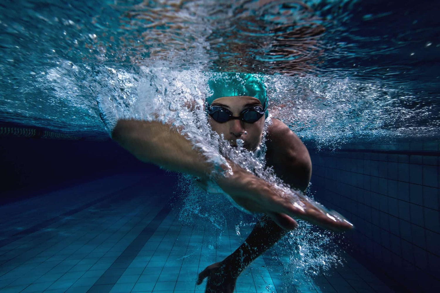 Underwater view of male swimming laps in lap pool